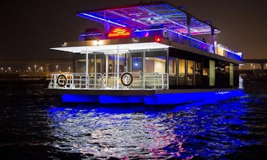 Enjoy Dinner Cruise aboard modern glass houseboat in Dubai