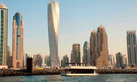 Enjoy Dinner Cruise aboard modern glass houseboat in Dubai