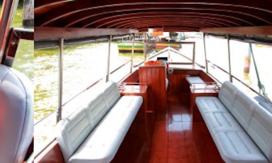 Smaller Sightseeing boat perfect for 16 people cruises on Chao Phraya River in Bangkok, Thailand