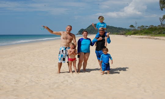 A happy family smiling on the deserted beach