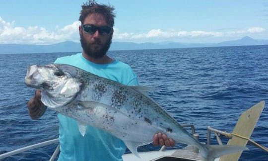 Luke and his Tea Leaf Trevally while reef fishing from Cairns.