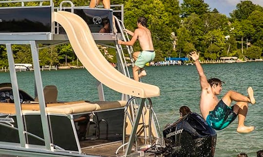Enjoy family fun with your own waterpark on the water! This double-decker pontoon is loaded with features like a slide with a water pump, a second-lev