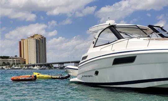 Vessel at anchor with 3 person float and 2 person Kayak floating off swim platform.