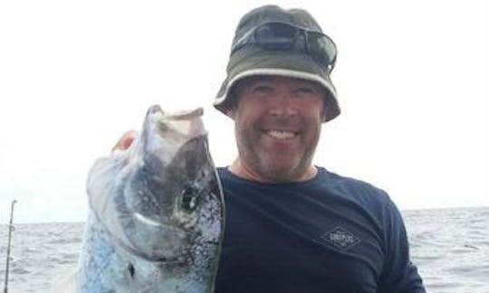 Scotty and his catch of a Trevally while reef fishing from Cairns.