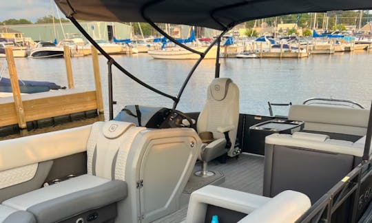 Lounger chair in front of the captains chair with cup holders.