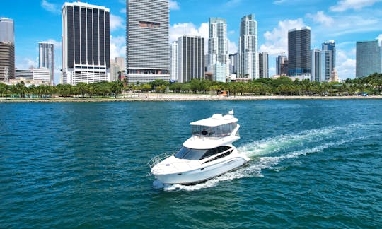 Meridian Yacht Drafting in Miami Water. Downtown Miami and Brickell. White Yacht Flybridge.