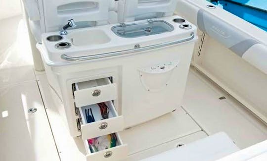 Ready to fish or just wash up, behind the helm the bait station features 2 cup holders, two rod holders, 3 drawer tackle center, large live well and f