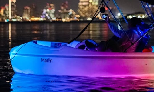 Night water activity on Point Loma. Cruise in San Diego Bay on Glowing pedal boat with a disco ball and a speaker