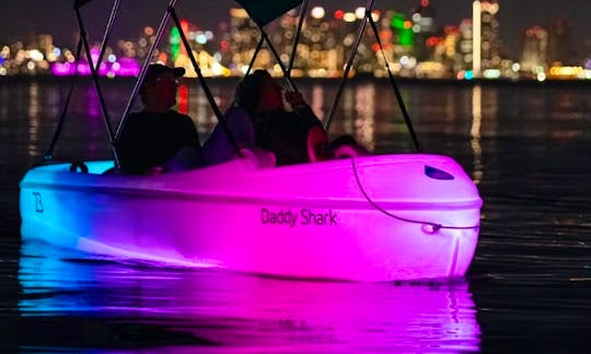 Night water activity on Point Loma. Cruise in San Diego Bay on Glowing pedal boat with a disco ball and a speaker