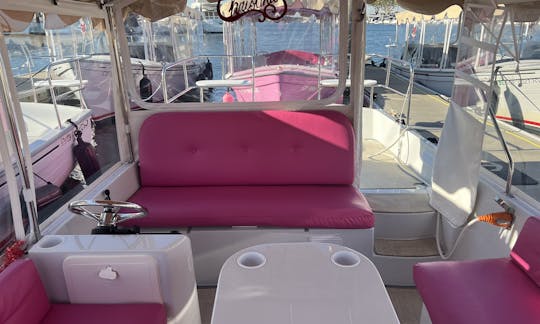 Barco Duffy elétrico rosa de 21 pés em Huntington Beach