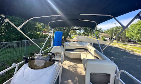 Sun Tracker Pontoon in Lake Austin